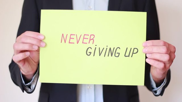 "Never giving up" inscription in male hands