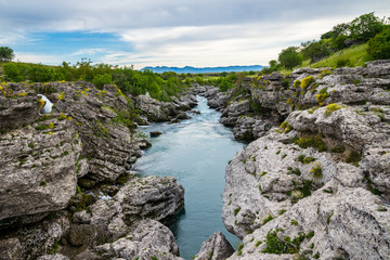 Naklejka na ściany i meble Montenegro, Beautiful unspoiled green nature landscape of river cijevna flowing through rocky canyon near podgorica at niagara falls
