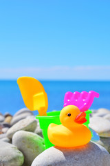 yellow rubber ducks on the beach background