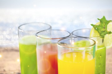 Tasty fruits  and juice with vitamins on background