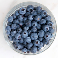 Blueberries in a glass dish.