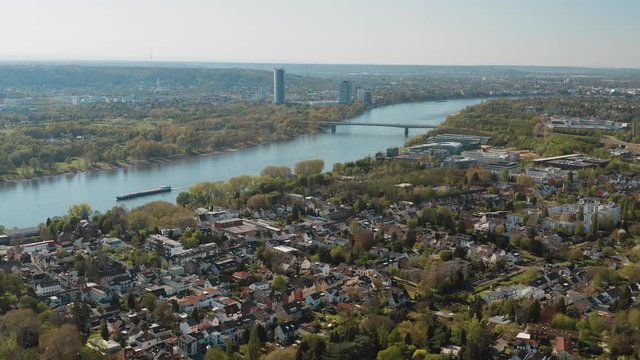 Drone / Aerial panorama shot bonn with the konrad adenauer bridge, the river rhine with a ship, the Kameha Grand hotel and the post tower 25p