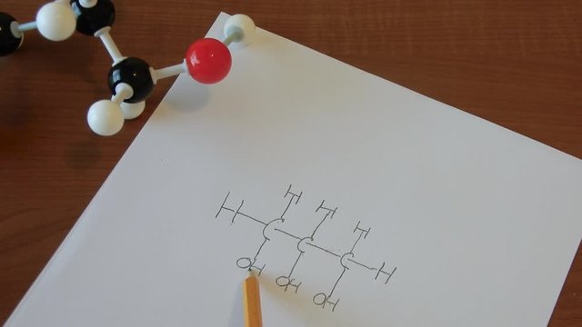 Person going over a chemical formula to insure accuracy