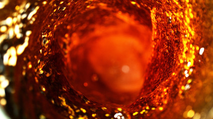 Detail of cola, tea or hard spirit beverages whirl, abstract fresh drink background