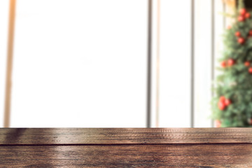 Empty vintage wood table top with xmas tree of winter season background.