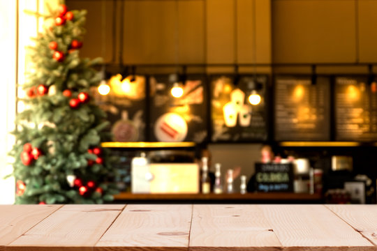 Empty Wood Table Top With Blurred Chistmas Holiday Background With  Coffee Shop (cafe) And Restaurant Shop.