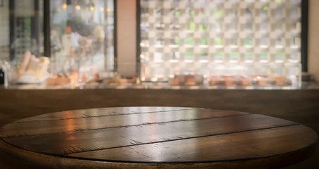 Fototapeta na wymiar Blank top dark wooden bar counter with blur cafe background.