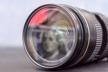 Lens from digital camera with dollar banknote reflection on it