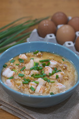 Steamed egg custard cuisine in a blue bowl with minced pork, sausage and shrimp. Or Only with egg, water, salt and some sesame oil, you can make this super smooth custard.