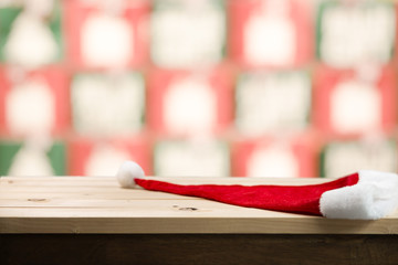 Christmas holiday background with empty wooden table top over christmas pine tree and house for montage product display.
