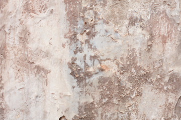 Old beige chipped wall with humidity stains texture background