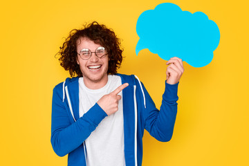 Cheerful nerdy guy pointing at thought bubble