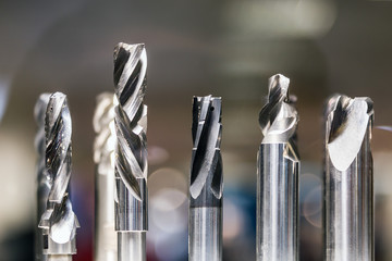 Drill bits in various sizes on the drill bit rack for Metalworking