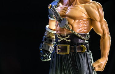 strong man warrior figure toy on black background