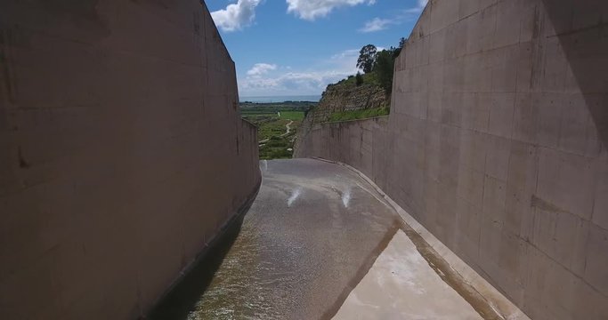 Drone Aerial Pov of Artificial Dam Concrete Water Channel With Water From Controlled Lake 4k