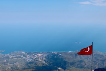 Fototapeta premium turkish flag in the wind, olympos telefirik, turkey