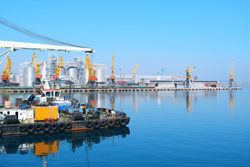 Industrial port on the black sea. Tugboat on the background of the seaport