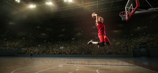 Female basketball player makes slam dunk. Basketball player on big professional arena during the game © Alex
