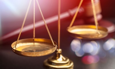 Justice Scales and wooden gavel on wooden table