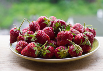 strawberries in plate on natural background