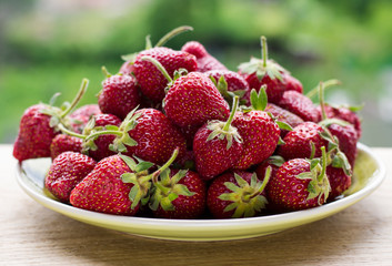 strawberries in plate on natural background