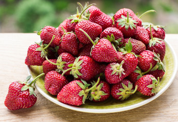 strawberries in plate on natural background
