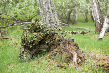 Camouflaged sniper in the forest