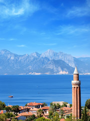 elevated view of cityscape image of historic district of Antalya over Mediterranean sea and high mountains with clear blue sky in Turkey