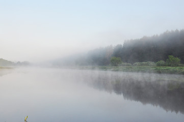 Fototapeta na wymiar Photo of fog over the river in the early summer morning