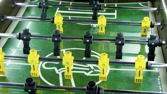 Sport, game concept. Foosball. People playing a table football or kicker with miniature players. 4K