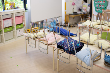Pillows linked to the chair on a kindergarten in Japan. These pillows will be used in case of an...