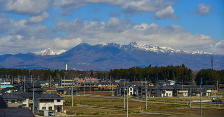 Cityscape with snow mountain in sunny day