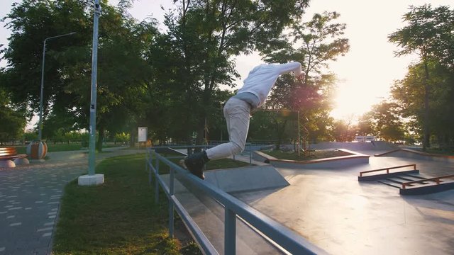 Aggressive Inline roller skater doing tricks in concrete skatepark outdoors, slow motion, tracking shot