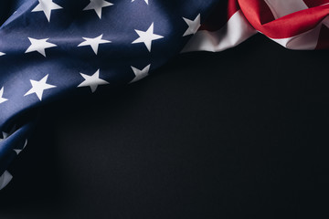 Folded American national flag isolated on black, memorial day concept
