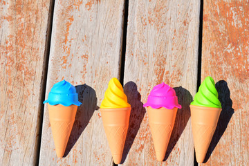colored ice cream cone on wooden background