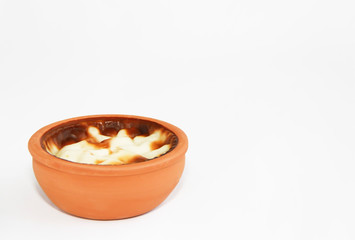 Turkish traditional sweet supangle dish in a clay plate on a white background 