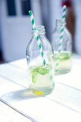 Two bottles with lemonade.