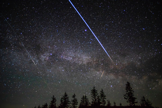 Flying through the night sky of the space station of satellites and meteors