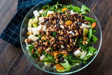 Pine Nut Salad with Walnut, Pear, Dried Apricot, Arugula or Rucola Leaves in Glass Bowl.