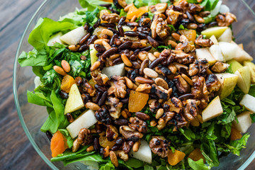 Pine Nut Salad with Walnut, Pear, Dried Apricot, Arugula or Rucola Leaves in Glass Bowl.