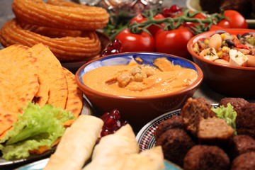 Middle eastern or arabic dishes and assorted meze, concrete rustic background. Falafel. Turkish Dessert Baklava with pistachio. Halal food. Lebanese cuisine