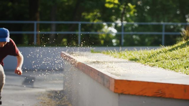 Aggressive Inline roller skater doing tricks in concrete skatepark outdoors with beautiful background, super slow motion