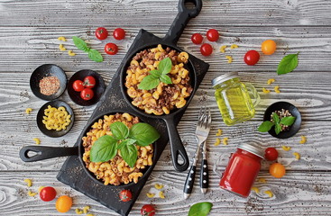 Pasta Elbow macaroni with minced meat in a cast iron skillet a La carte. Pasta Elbow macaroni with...