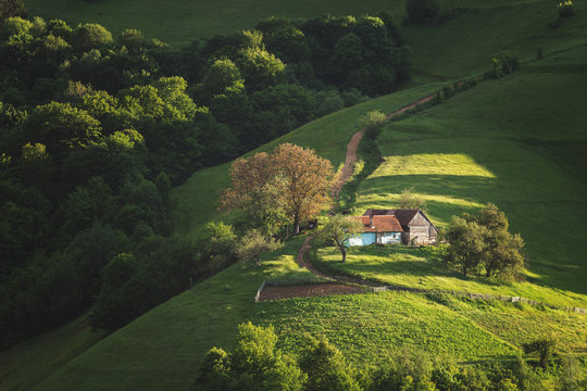 Beautiful summer green hills in Transylvania. Sunrise landscape in the Romanian mountain village
