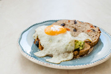 Fried Egg with Avocado on Toast Bread for Breakfast