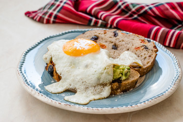 Fried Egg with Avocado on Toast Bread for Breakfast