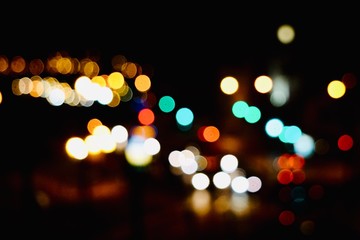 colorful bokeh lights in the street in the city at night