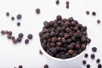 Black Pepper in white bowl on white background
