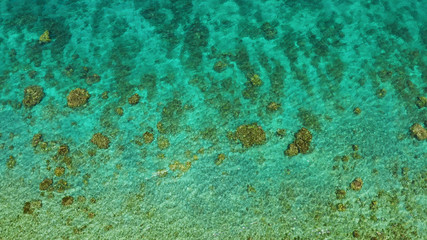 Transparent sea water copy space for text, top view. Aerial view of calm sea water. Top view of a clean ocean water near a coast.