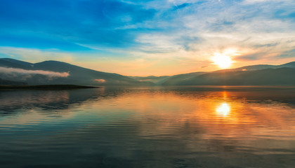 Fototapeta na wymiar Colorful sunset over a mountain lake